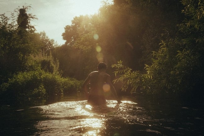 Garçon se baignant dans une rivière